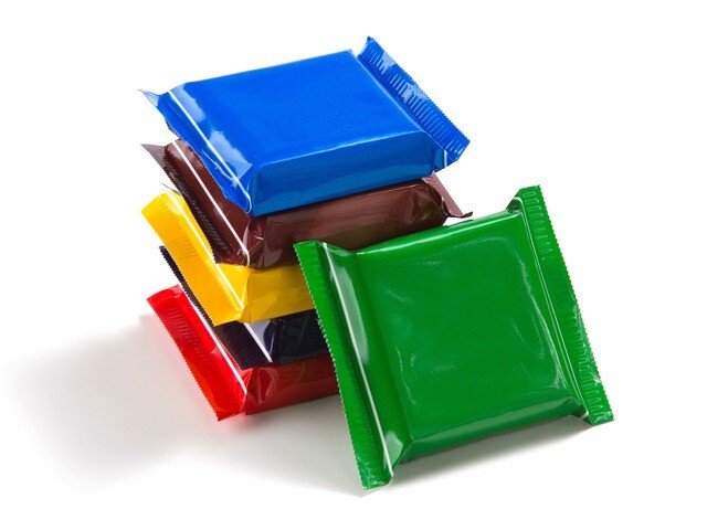 Chocolate and confectionery bars flow-wrapped with cold seal adhesive